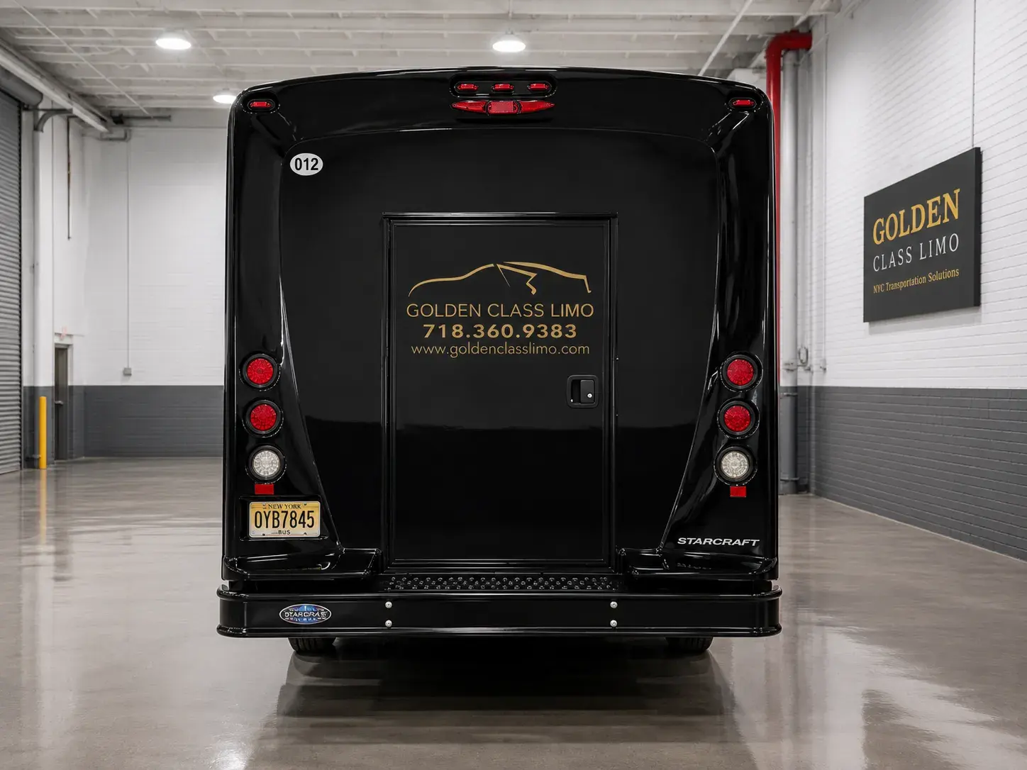 Black Golden Class Limo mini bus with gold lettering, in the company garage